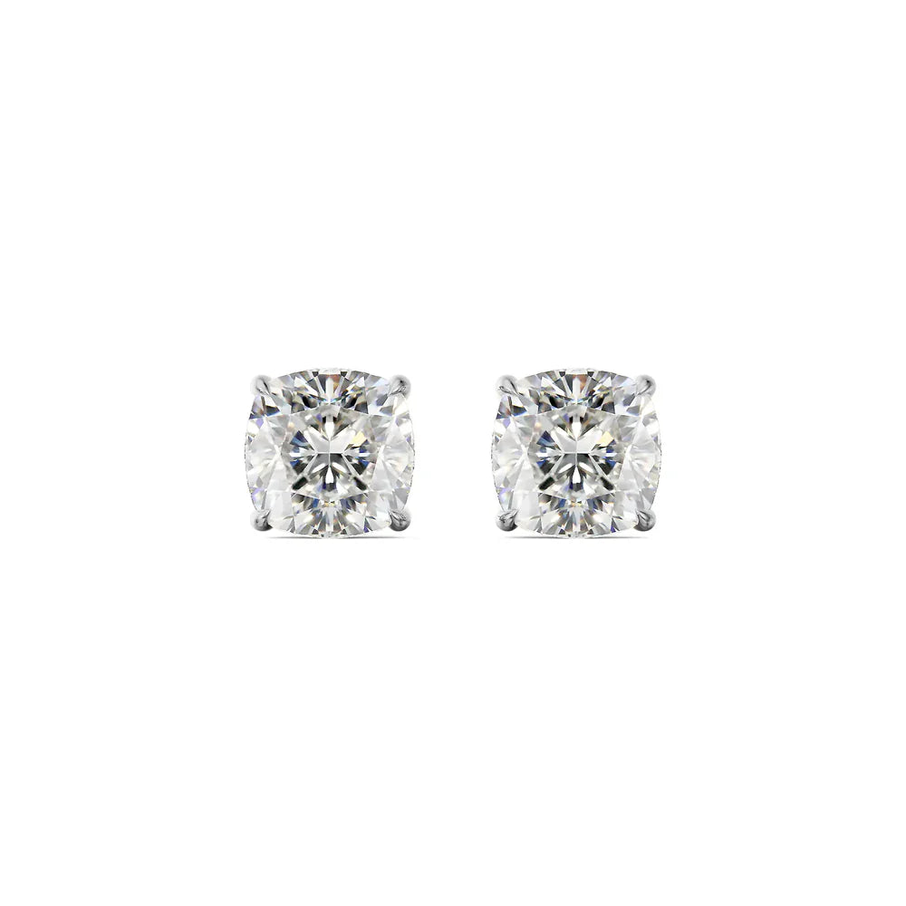 Gold and silver diamond stud earrings on a white background