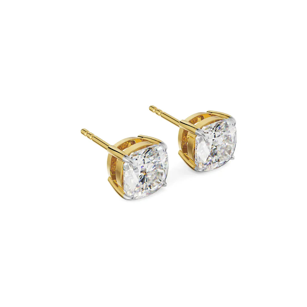 Gold earrings with clear gemstones on a white background