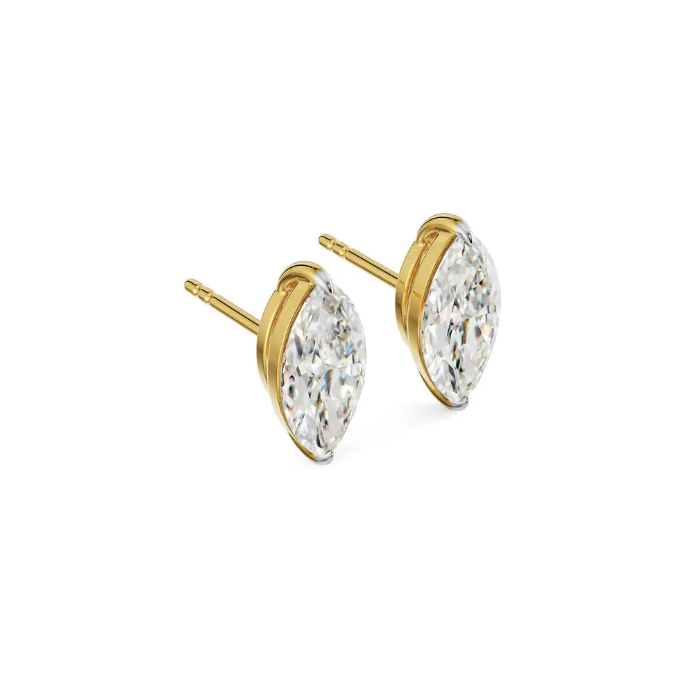Gold earrings with clear gemstones on a white background