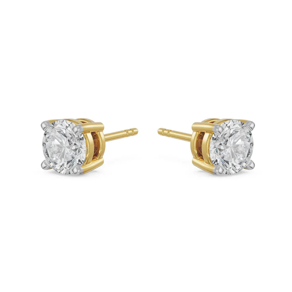 Gold diamond stud earrings on a white background