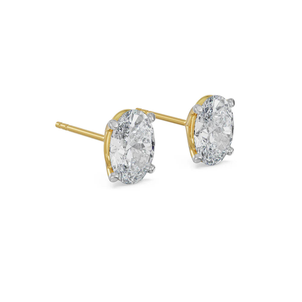 Gold and silver diamond stud earrings on a white background