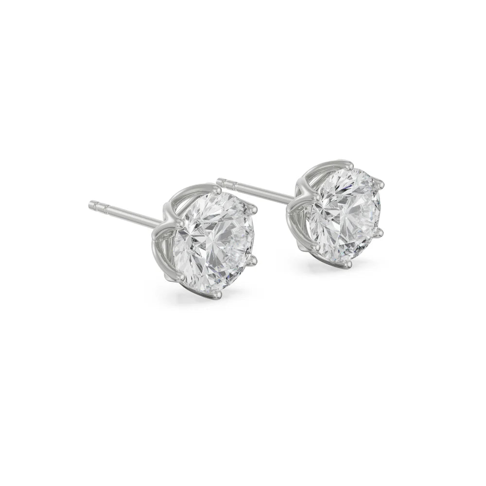 Pair of diamond stud earrings on a white background