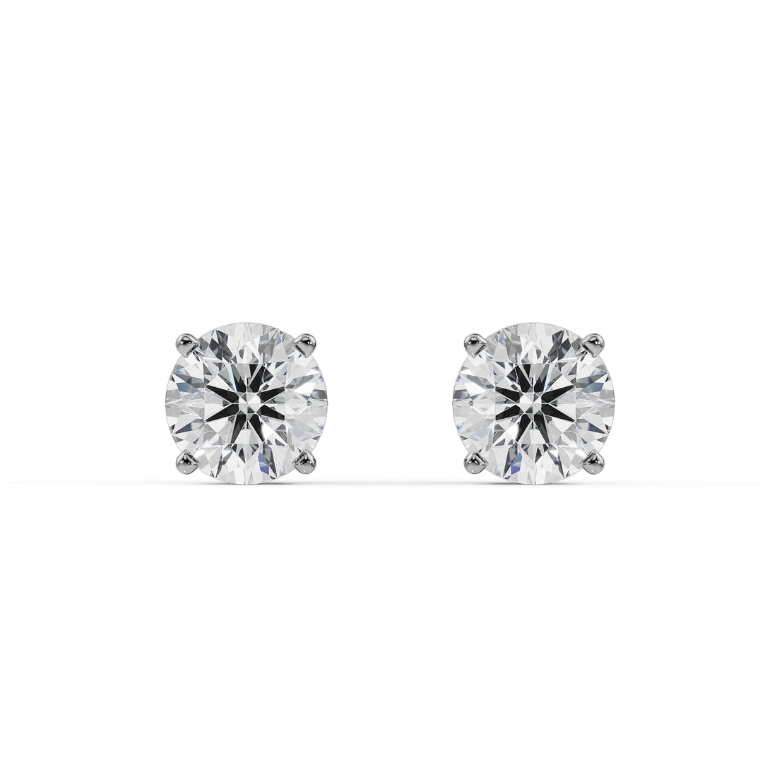 Gold and silver diamond stud earrings on a white background