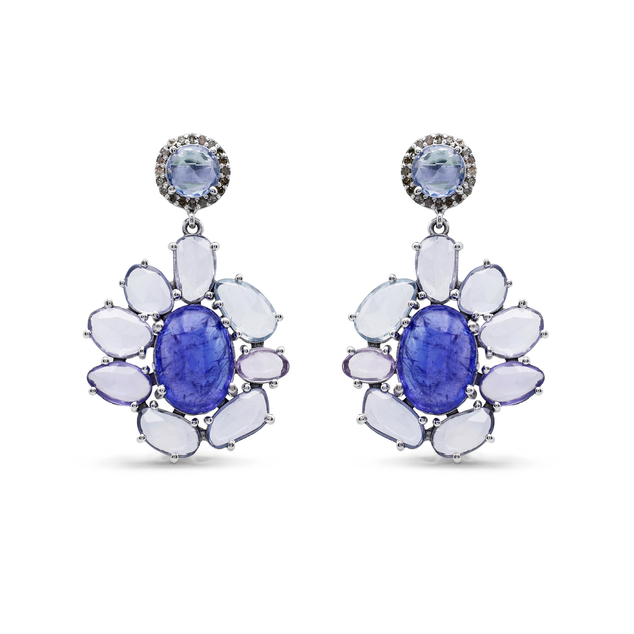 Pair of earrings with blue gemstones and white stones on a white background