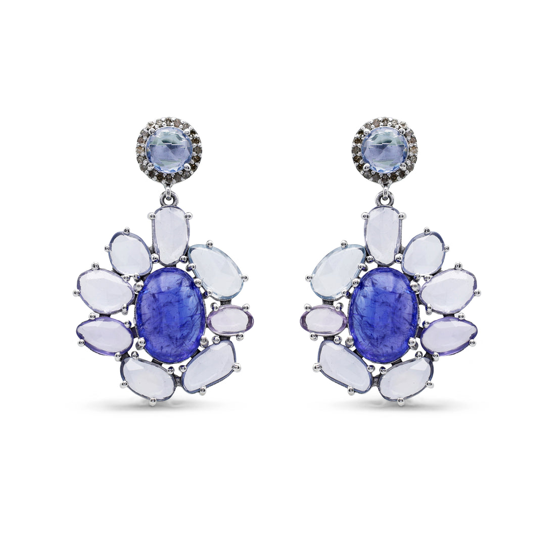 Pair of earrings with blue gemstones and white stones on a white background