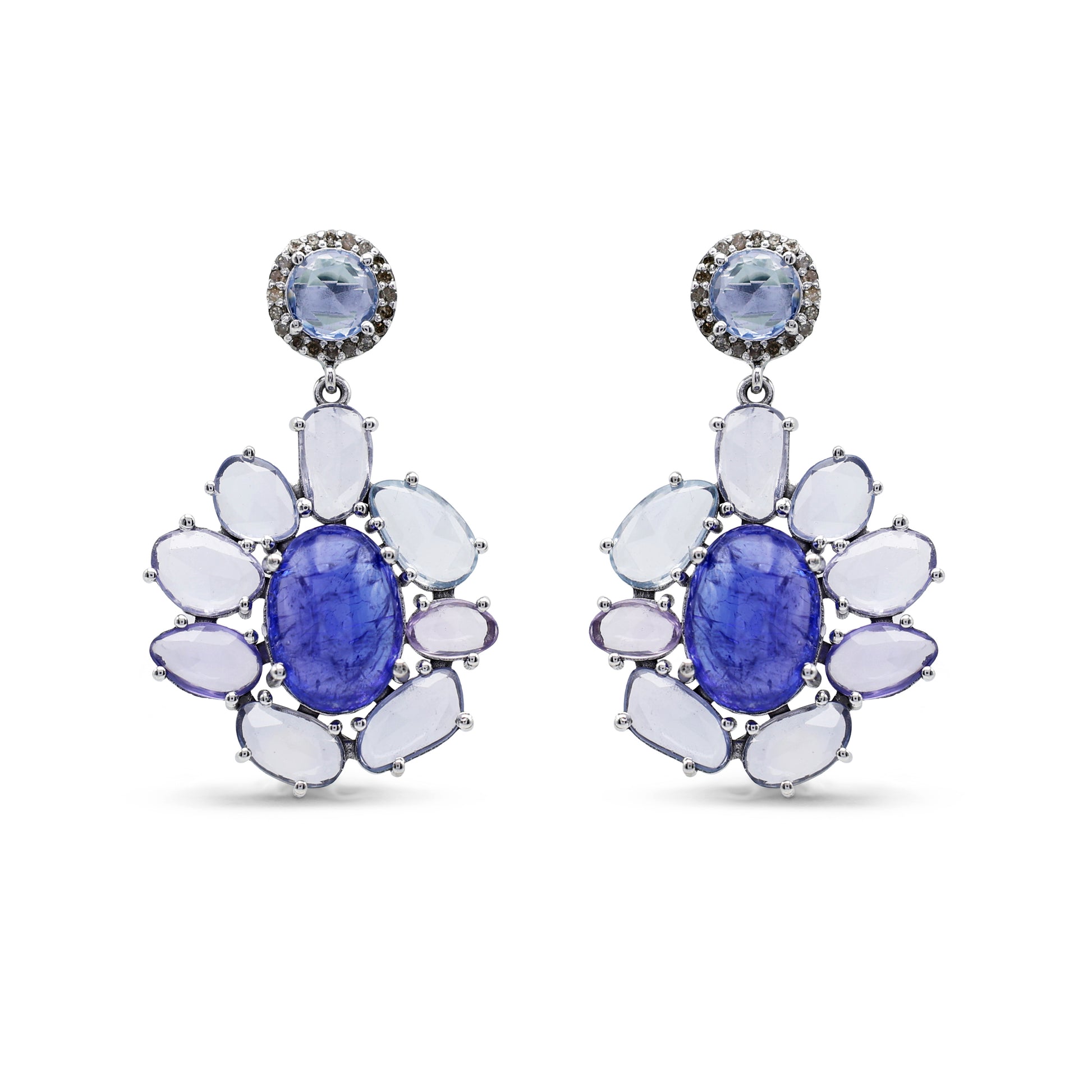 Pair of earrings with blue gemstones and white stones on a white background