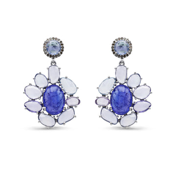 Pair of earrings with blue gemstones and white stones on a white background