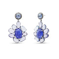 Pair of earrings with blue gemstones and white stones on a white background
