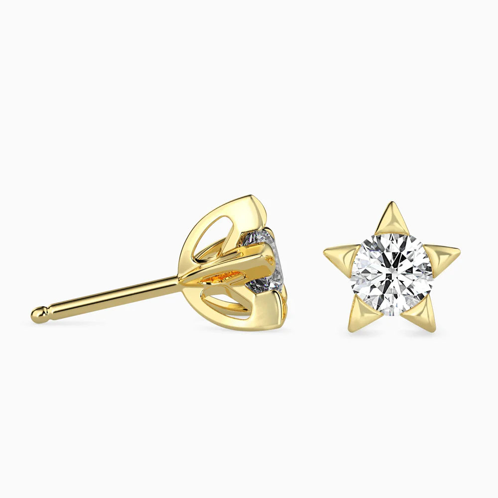 Gold earring with a diamond on a white background