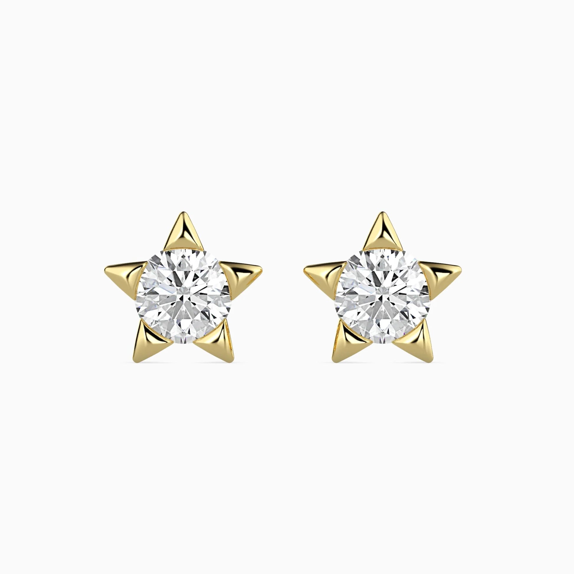 Gold star-shaped earrings with clear gemstones on a white background