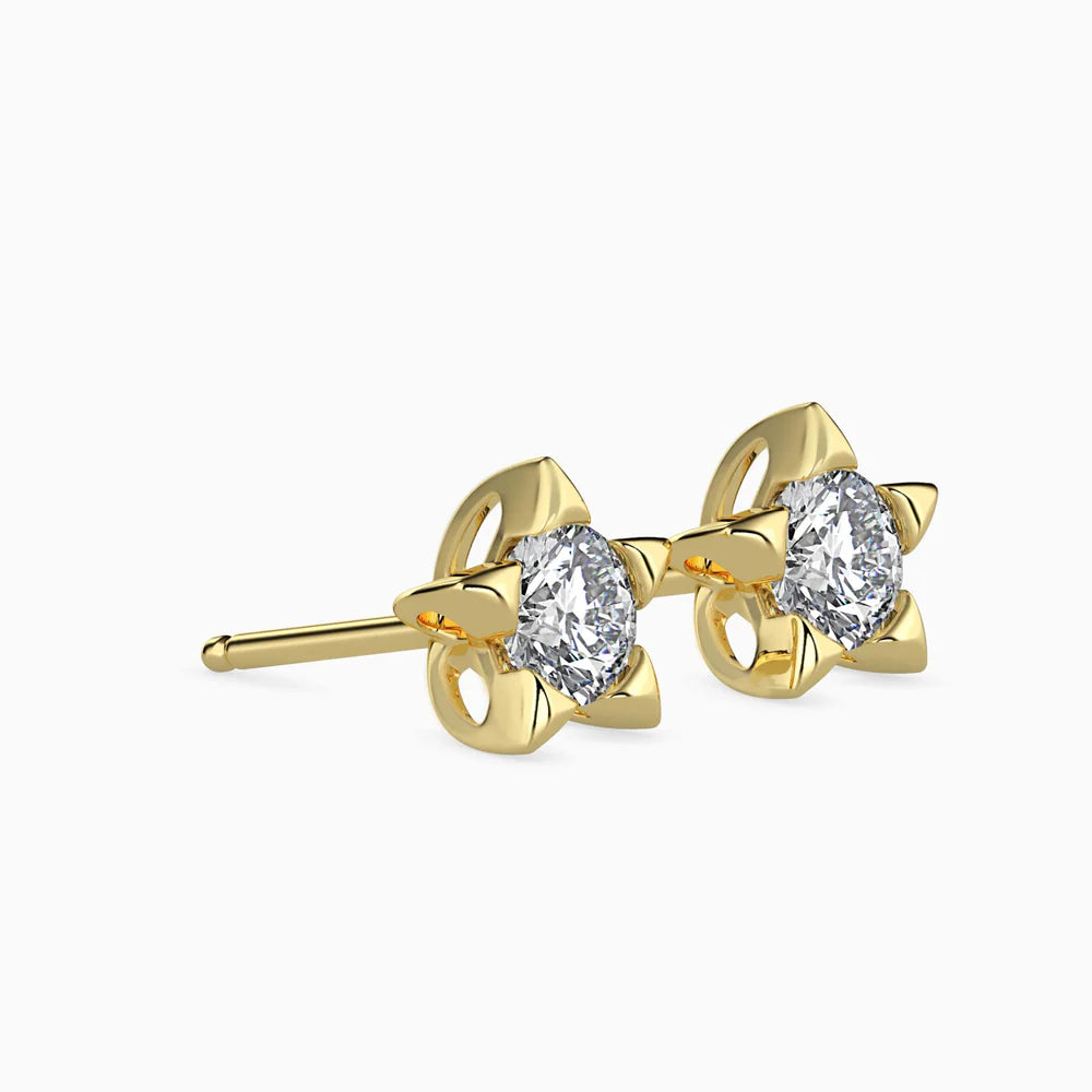 Gold earrings with pear-shaped gemstones on a white background