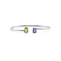 Silver ring with green and purple gemstones on a white background